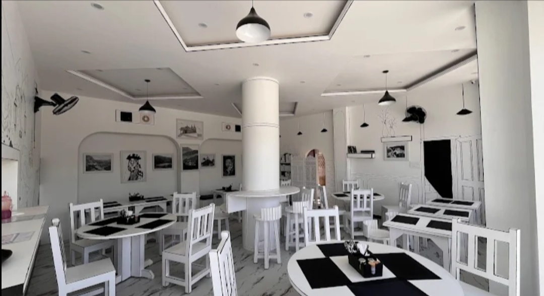 Cafe Syaahi monochrome dining room with white chairs
