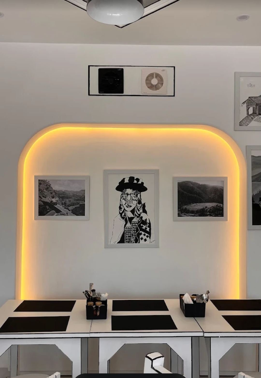 Cafe Syaahi interior with amber-lit arch and Himachali art